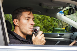 A Man Taking A Breathalyzer Test