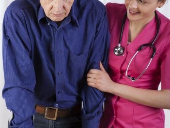 Nurse helping man walk