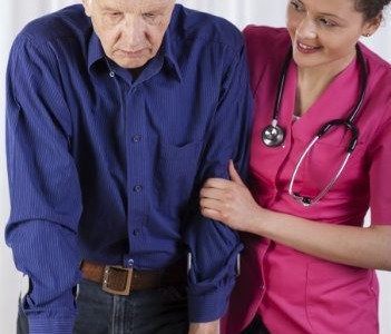 Nurse helping man walk