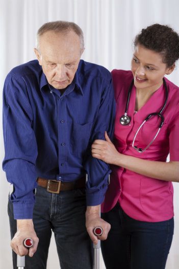 Nurse helping man walk